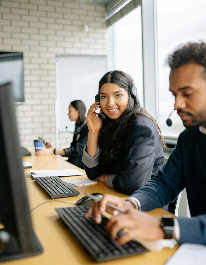 Team of diverse call center agents collaborating efficiently in a modern office.